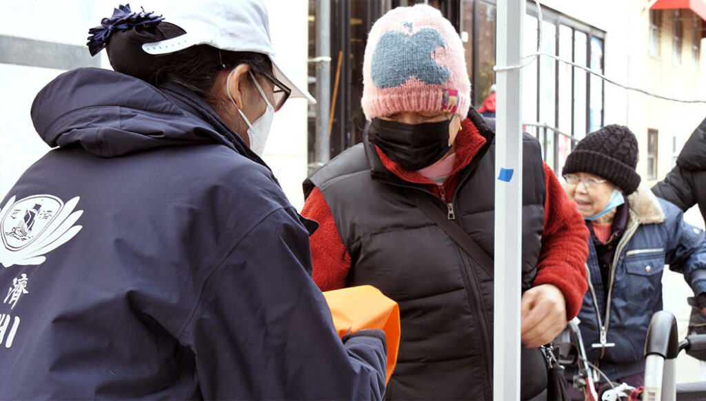 Tzu Chi volunteer distributing hot meals