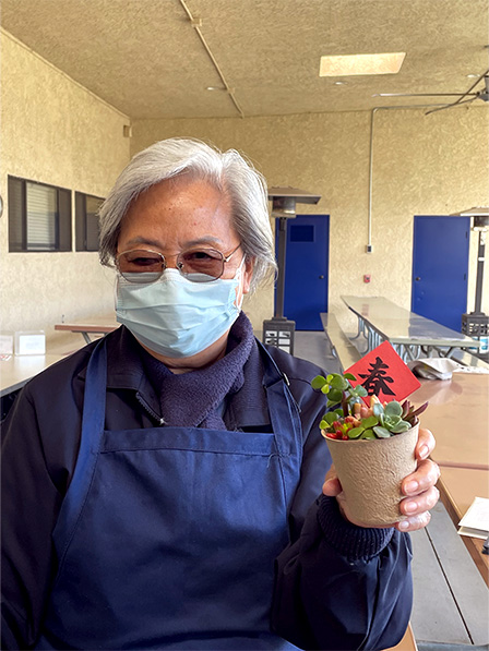 Tzu Chi volunteer holding the plant