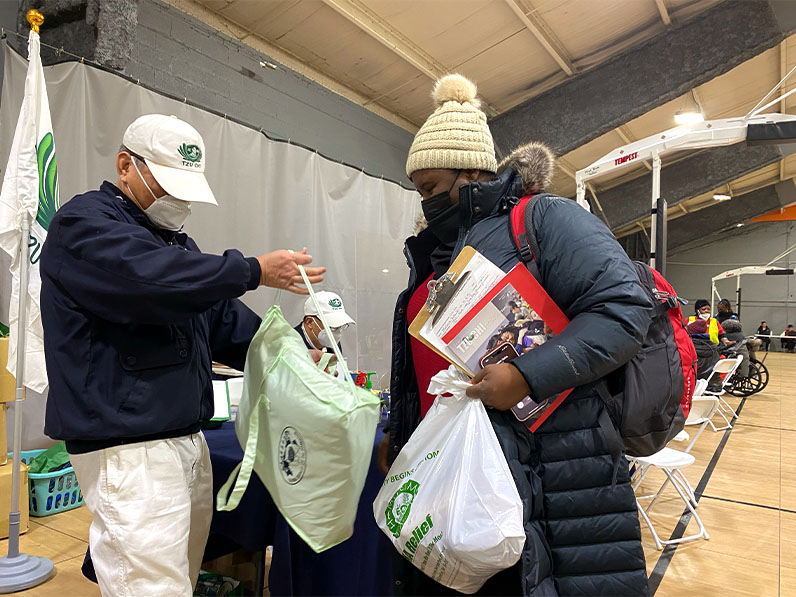 Tzu Chi volunteer distributing supplies