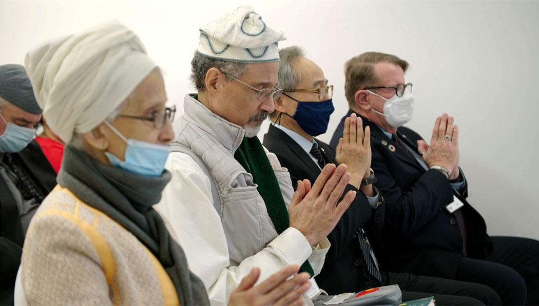 Interfaith leaders praying
