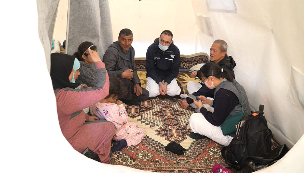 Tzu Chi volunteers and Turkey locals sitting in a tent