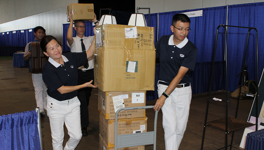 Tzu Chi volunteers carrying boxes together