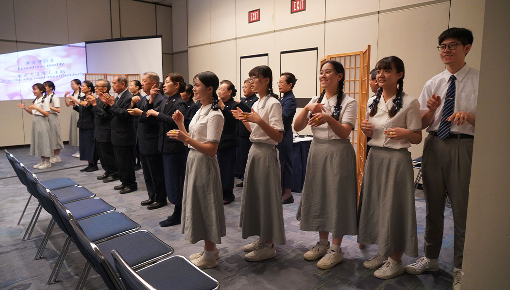 Volunteers express the song “Give Love” in sign language during a performance on the closing day of the 2023 PoWR.