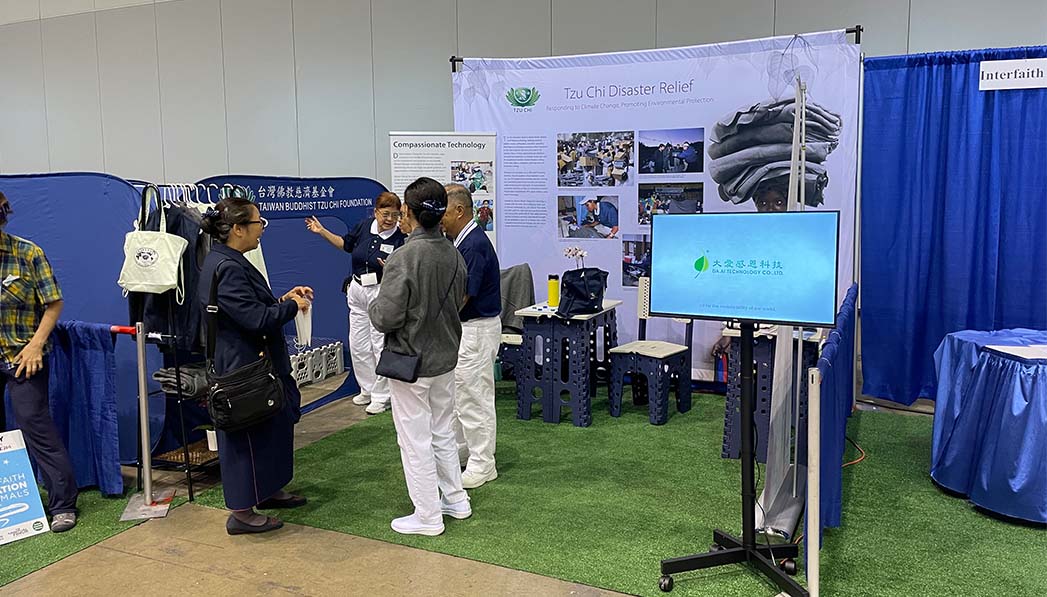 Volunteers prepare for visitors to Tzu Chi’s booth in the PoWR’s Climate Village.