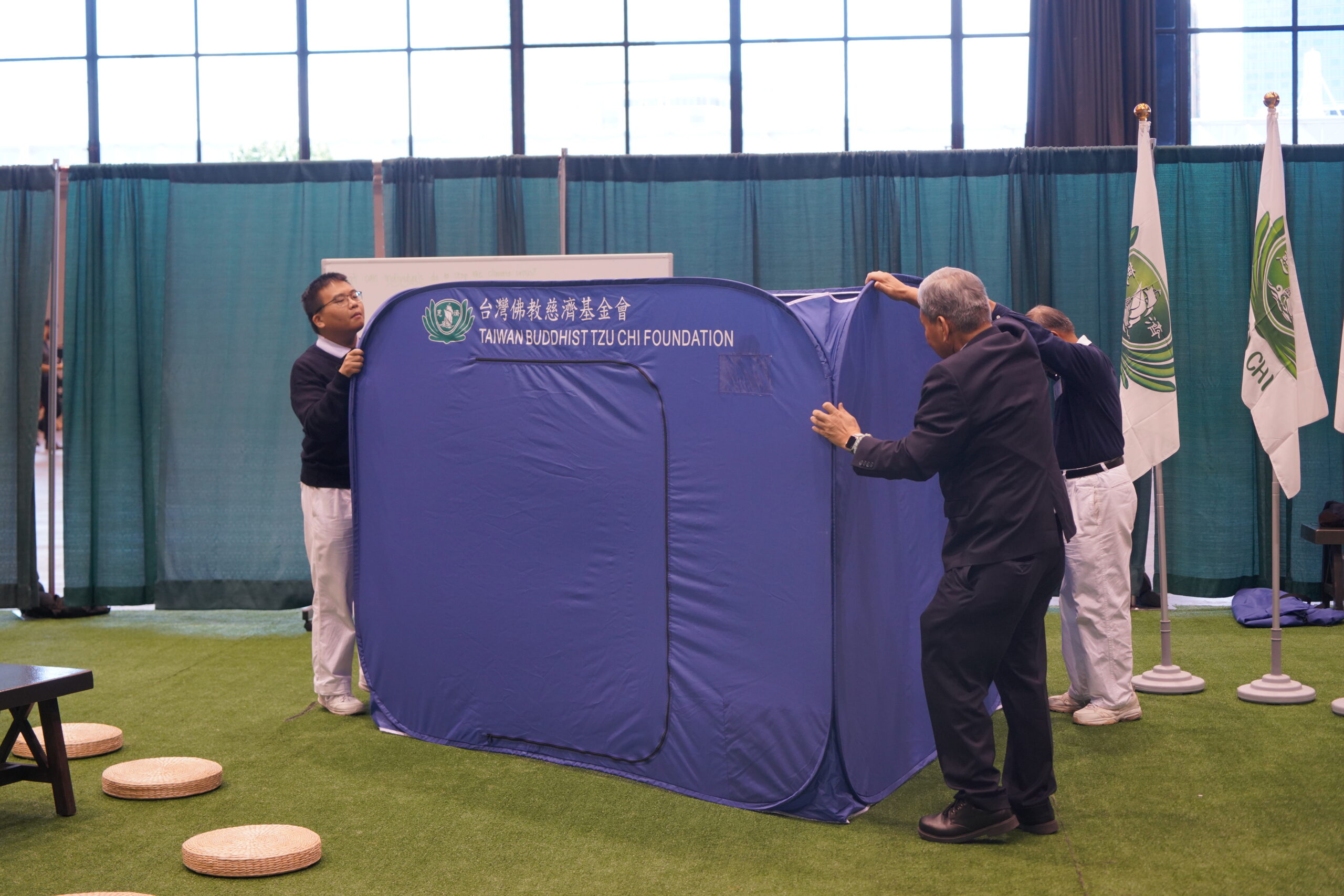 Tzu Chi volunteer showing ECO multipurpose tent