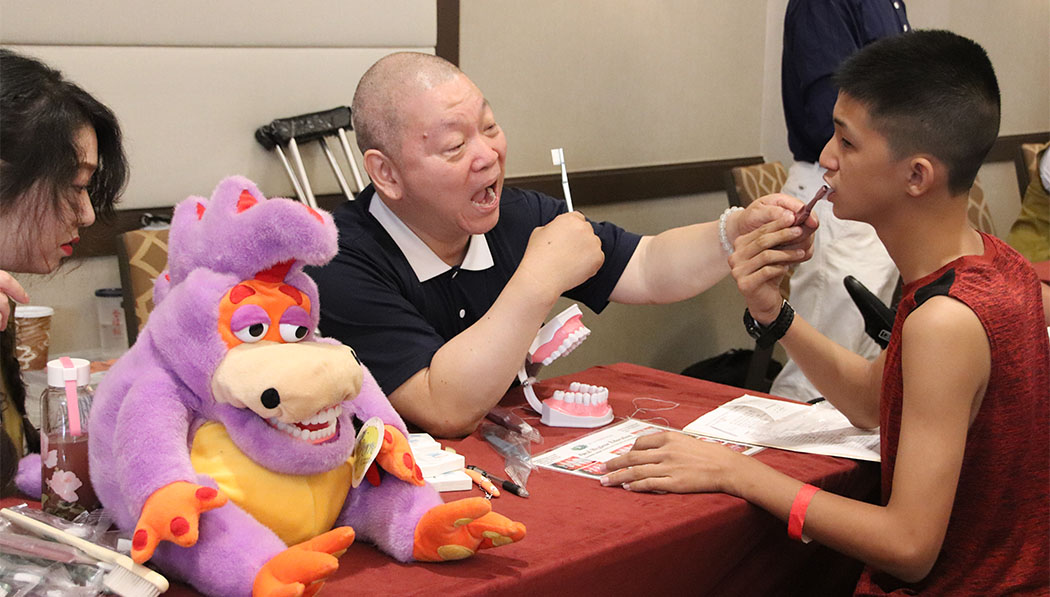 volunteer King Wu provides dental care education