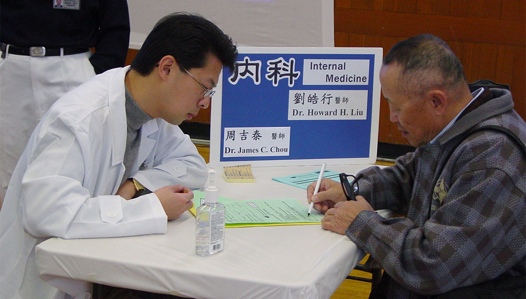 TIMA Boston doctor Dr. Howard Liu interacting with patient