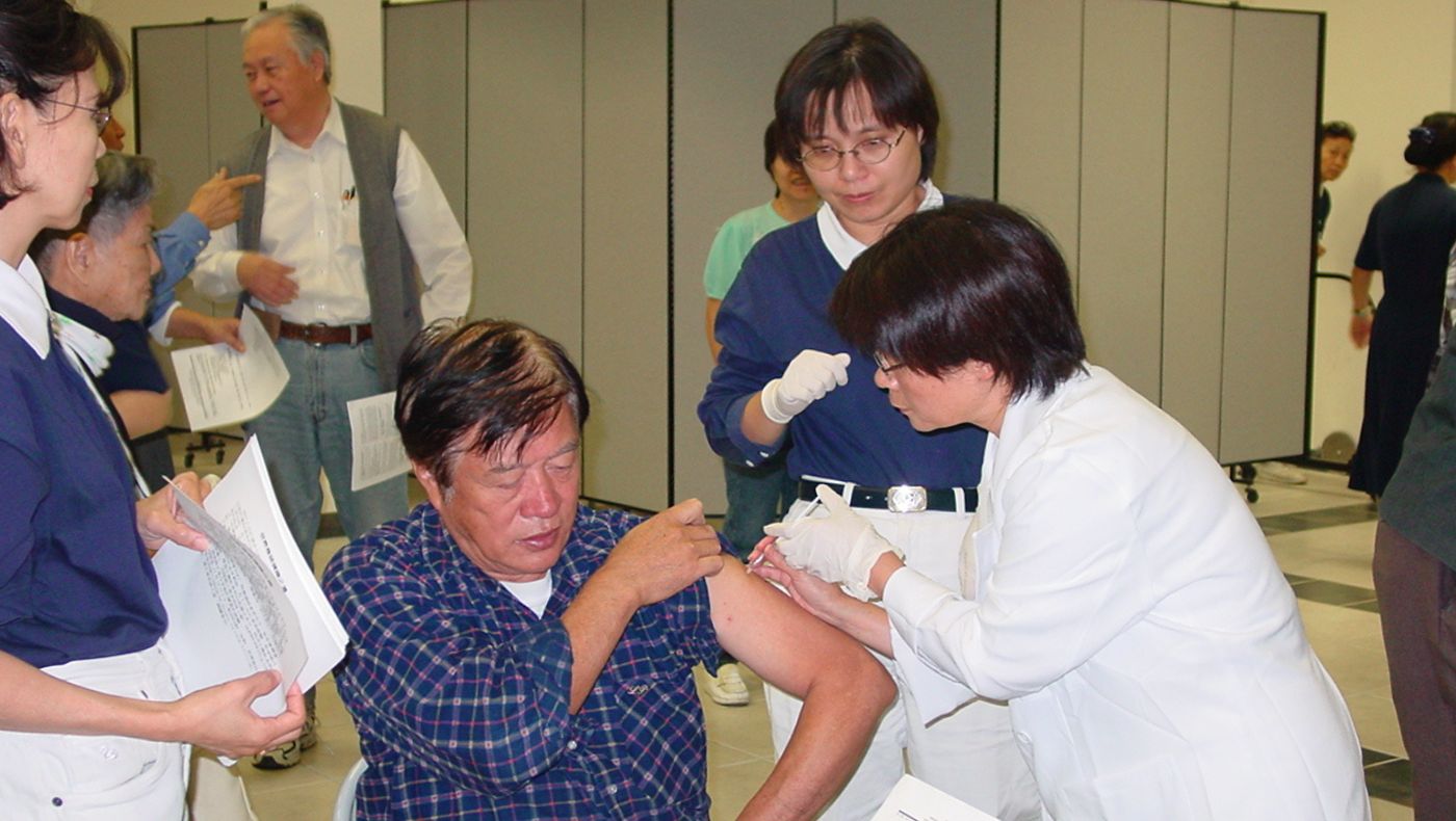 healthcare workers administer flu vaccines to the public
