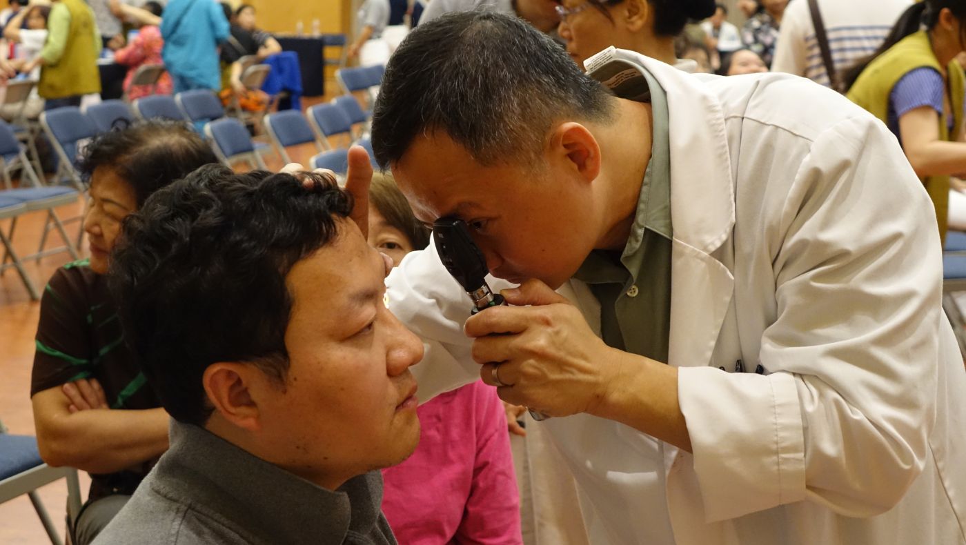 An ophthalmologist conducts eye exams