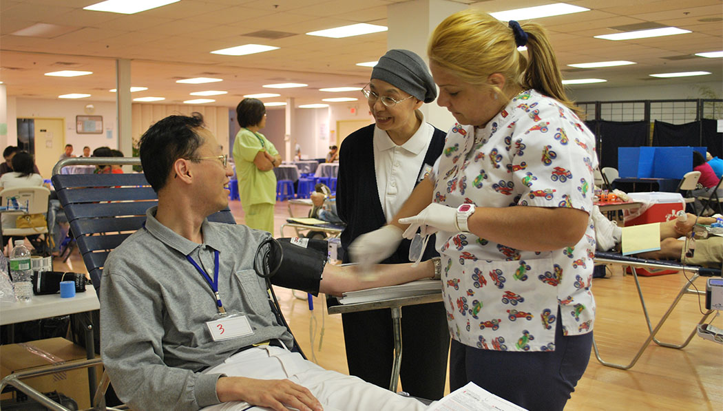 At a blood donation event, Dr. Hueiju Lin (middle) treats patients as family