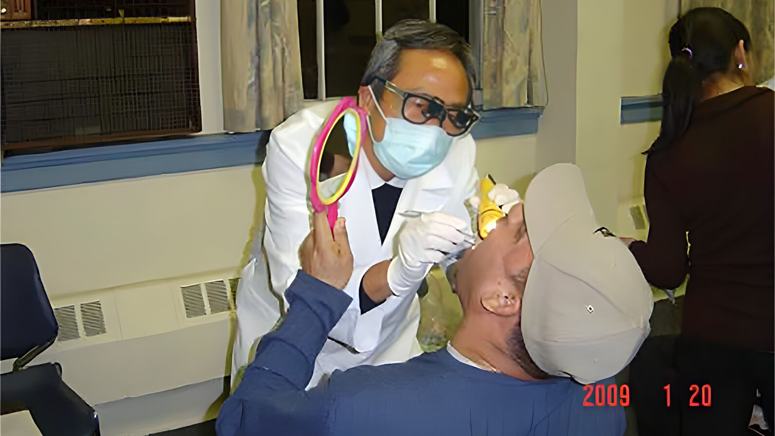 Dr. Kenneth Liao conducts an oral cancer screening