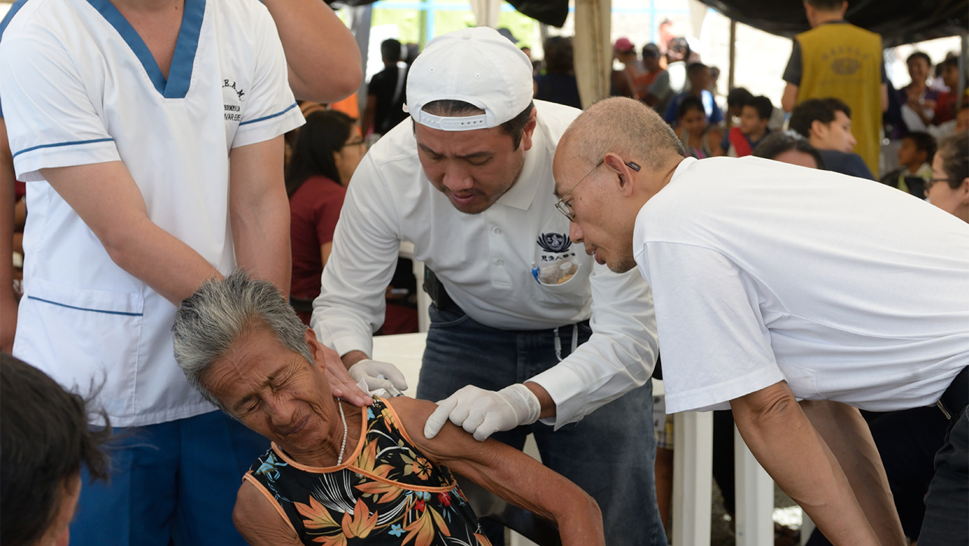 Volunteers provide vaccinations to the lady
