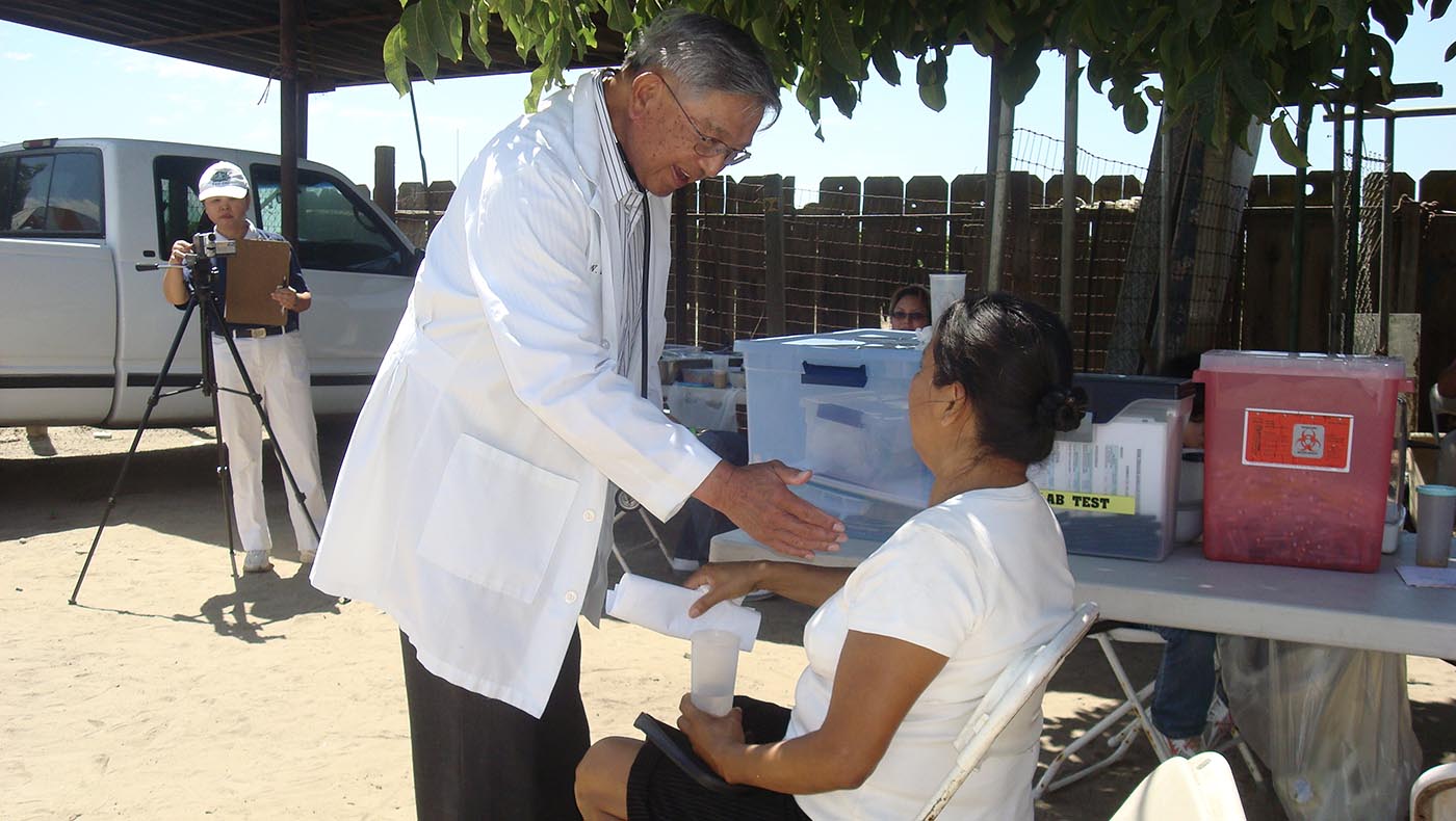 Dr. Walter Fung interacts with patients when the Fresno medical team travels to Caruthers, a census-designated place in Fresno County, to hold a free clinic for farmworkers