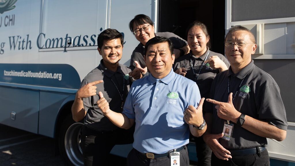 Steven Voon (middle) poses for a group photo with Fresno’s medical volunteers.