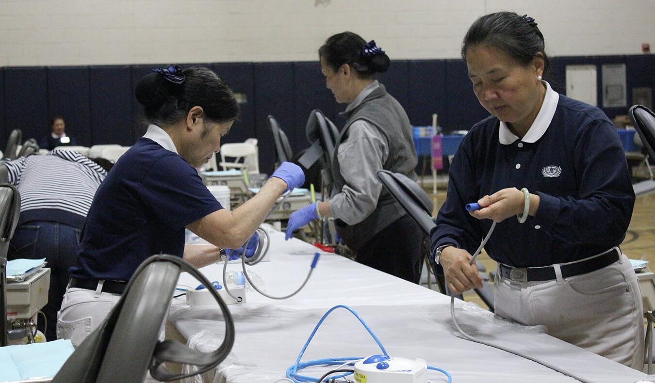 Volunteers prepare for a free clinic the next day, March 15, 2013, at Sunnyside High School in Fresno.