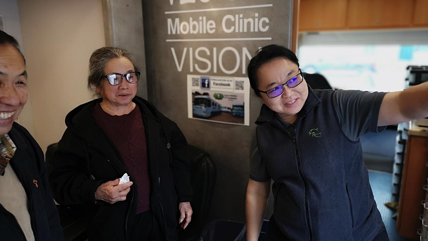 Olivia Chung (right) provides vision checkups for older community members during a free vision care clinic on December 3, 2019.