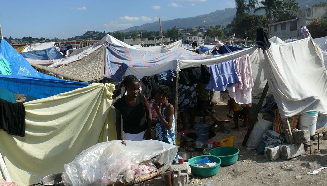Haitians live in tents made of tree branches and thin sheets