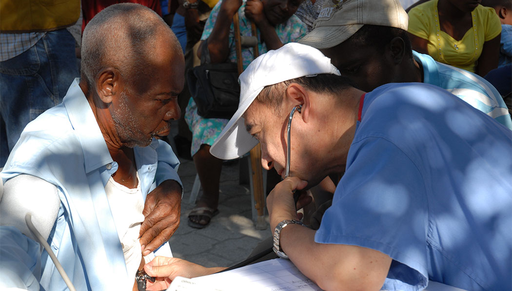 Dr. Matthew Lin checking the patient's physical condition with a stethoscope