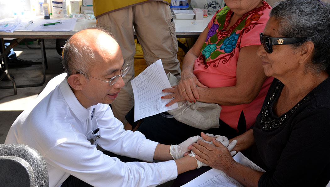 Tung Ping Cheung giving medical treatment to earthquake survivor