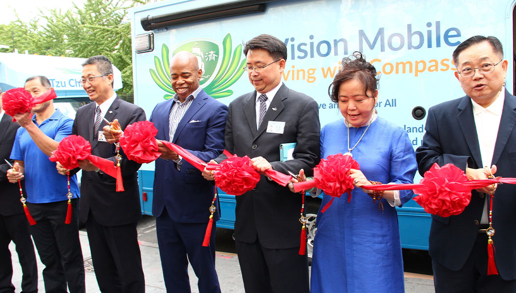 Richard Yang (third from right) cuts the ribbon for the launch of the Vision Mobile Clinic in New York