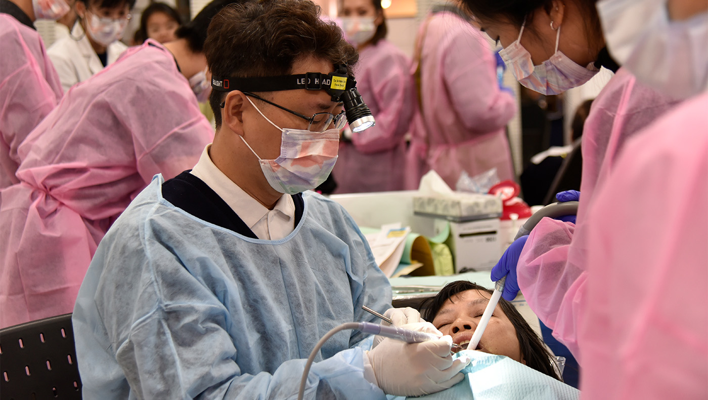 Richard Yang giving dental treatment to patient