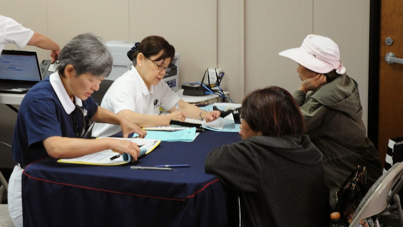 In June 2013, shortly after the designated free dental clinic opened, Samantha Mahaffey (second from left) helped register patient information.