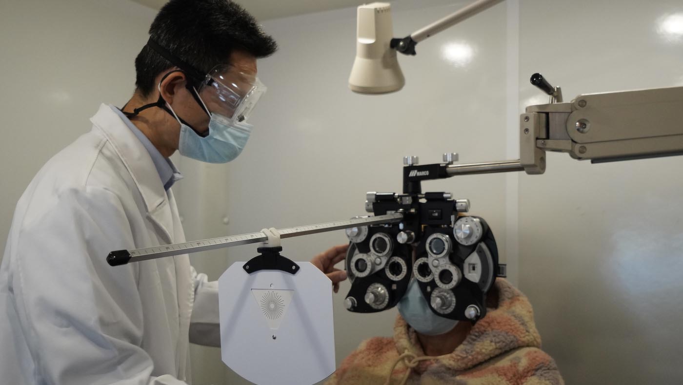 Optometrist James Chuang determines a patient’s vision correction prescription.
