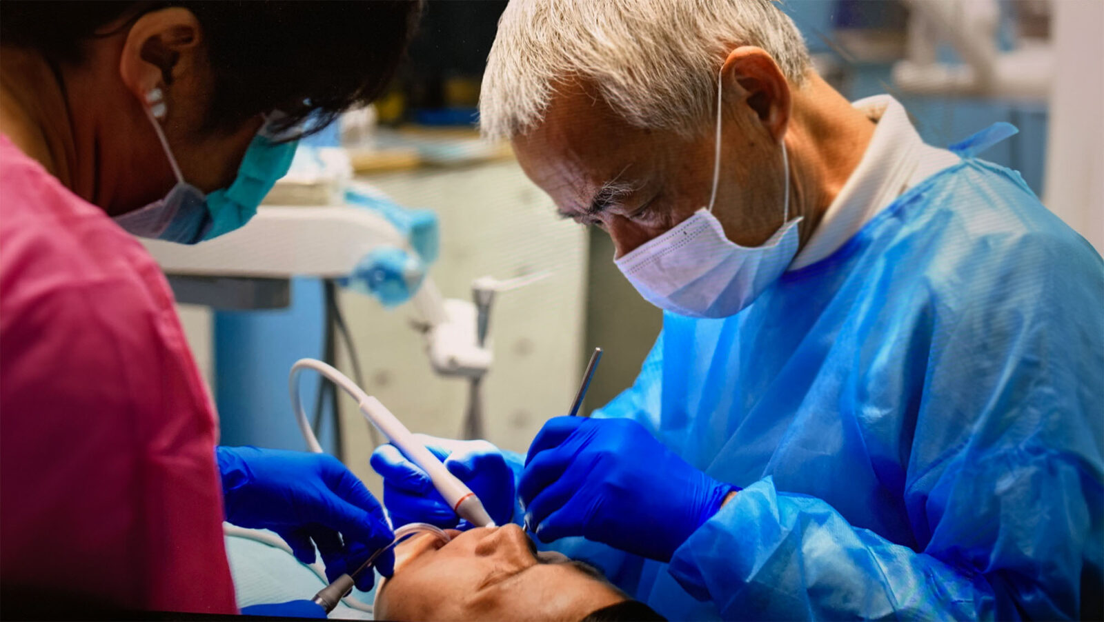 Dr. Lawrence Lai treats people's teeth at a free clinic.