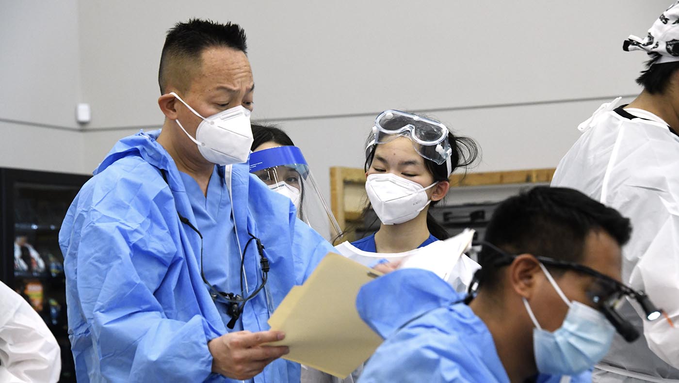 TIMA Las Vegas dentist Phan Nguyen carefully reviews patient intake forms. Photo/Peter Simmon