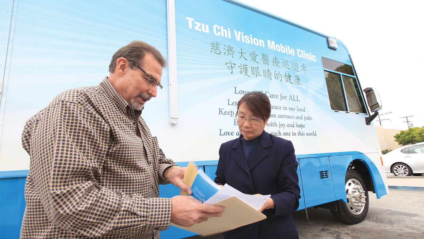 Debra in front of a Tzu Chi Vision Mobile Clinic