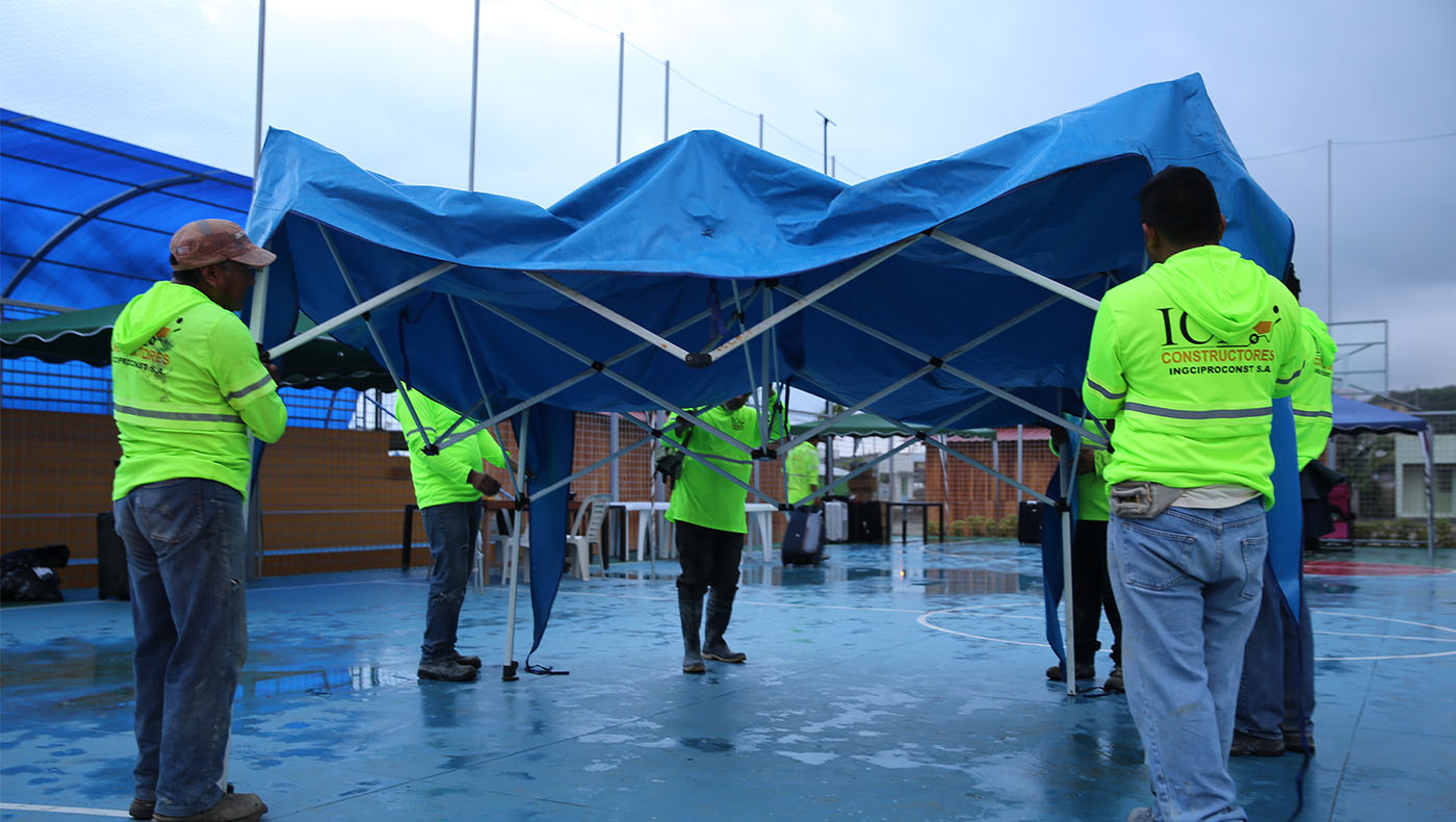 Volunteers re-erected the big tent that was knocked down by the rain