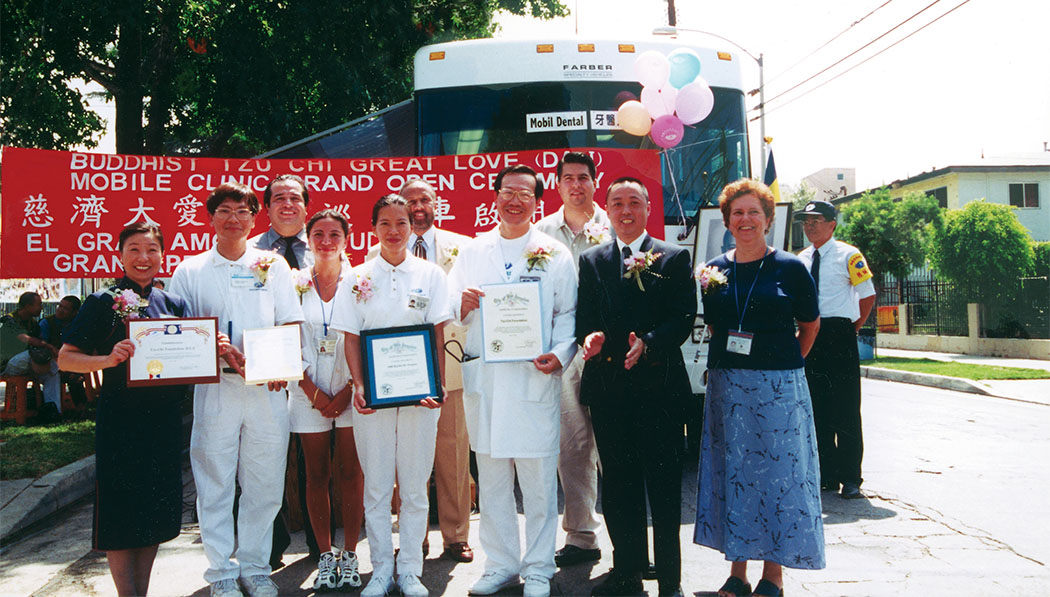 Volunteers standing in front of Tzu Chi USA’s first Mobile Clinic
