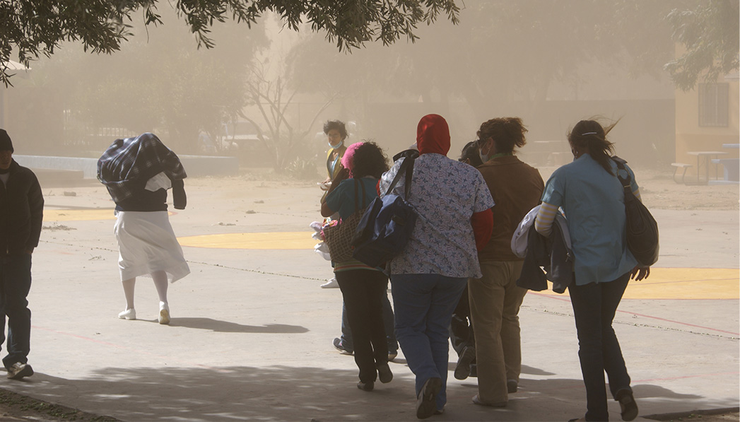 determined locals trek out during a sandstorm to see a doctor