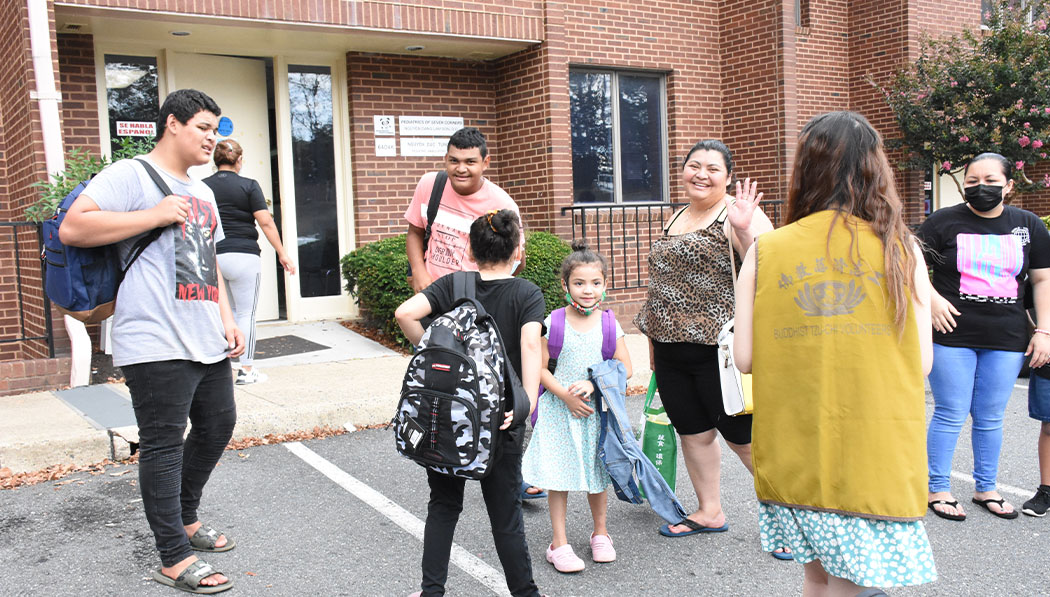 In one of their annual Backpacks for Kids distributions, families receive supply-filled backpacks as children start the 2021-2022 school year, along with packs of PPE.