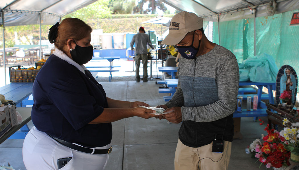 A touching moment as Torrance Service Center works with IDEPSCA to provide PPE to day laborers in Wilmington, California.