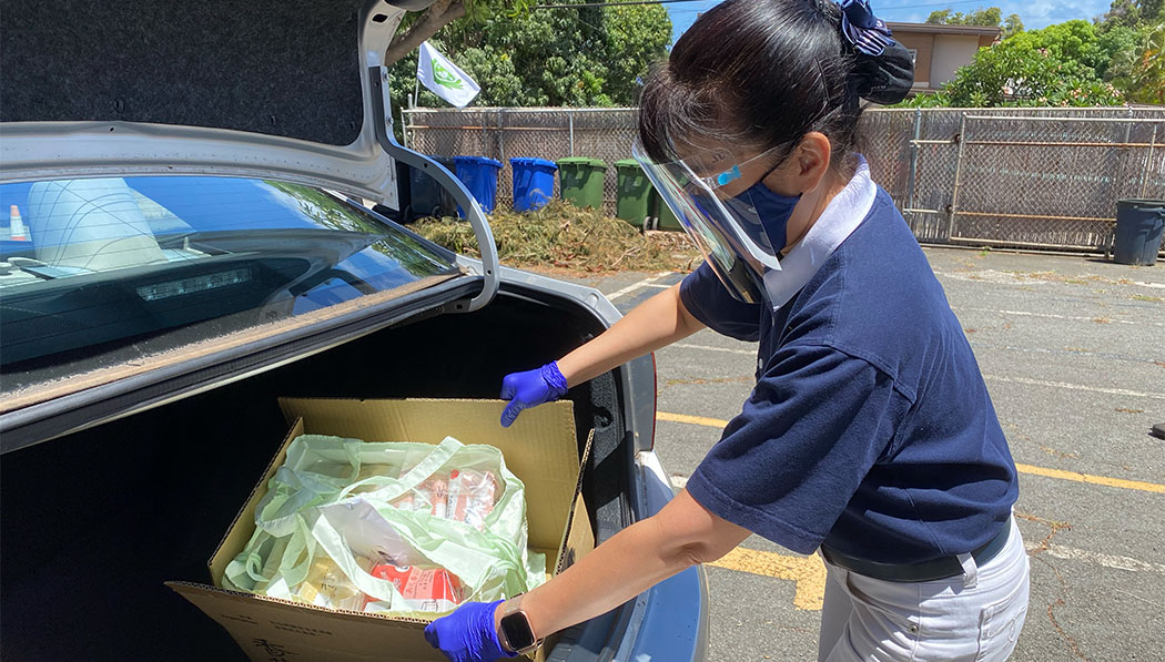 The distribution of items is done by drive-thru format to minimize contact, while allowing exceptions for outdoor pickup for those without vehicles.