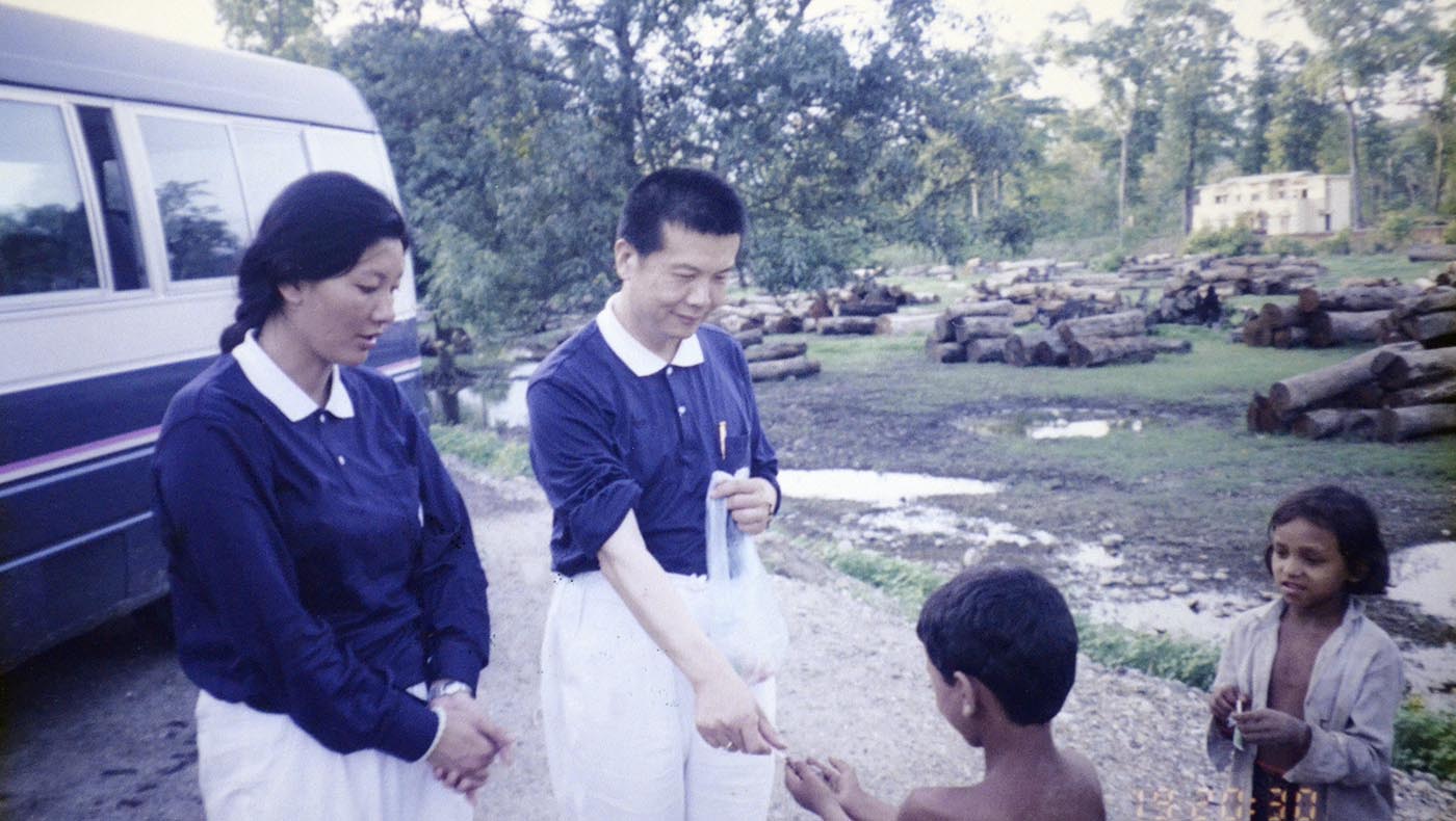 1996年6月19日，陳健與依格·古倫（Hegay Gurung）在前往因尼泊爾山洪水災而建的慈濟村路途中，與當地兒童互動。圖片來源／賑災團提供