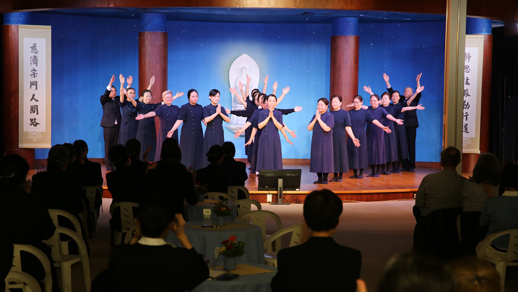 Volunteers perform the sign language World of a Thousand Hands, extending compassion and love infinitely
