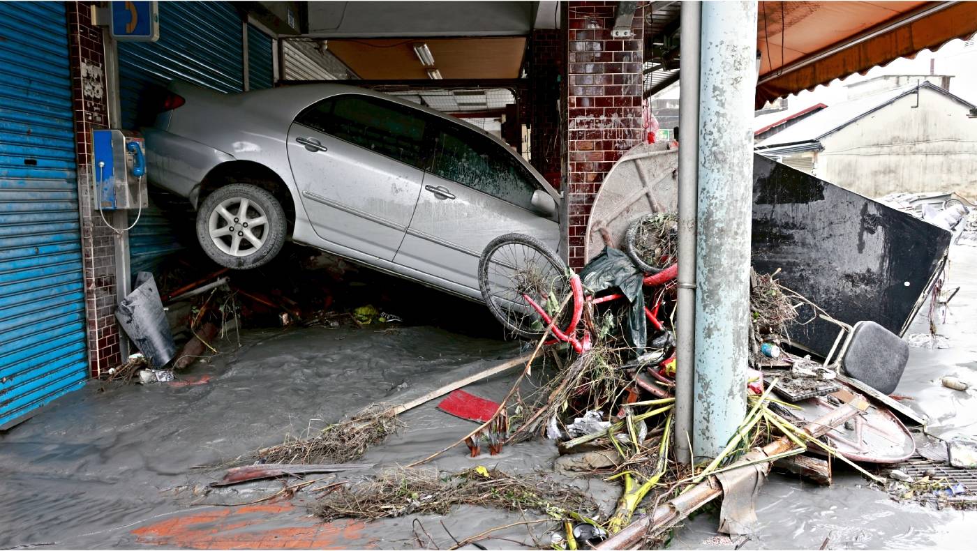As floodwater receded, Guangfu Township lay scarred and devastated, with vehicles hanging precariously from where they had been swept away. Photo/Mingtao Lo