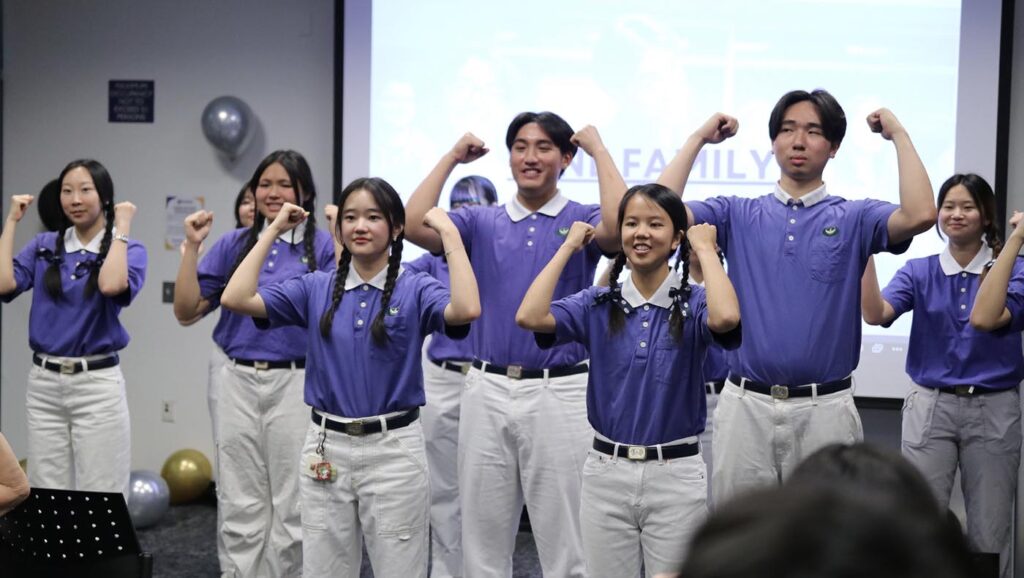 Melinda Wu (front row, right) leads a sign language performance as Tzu Chi Collegiate Association