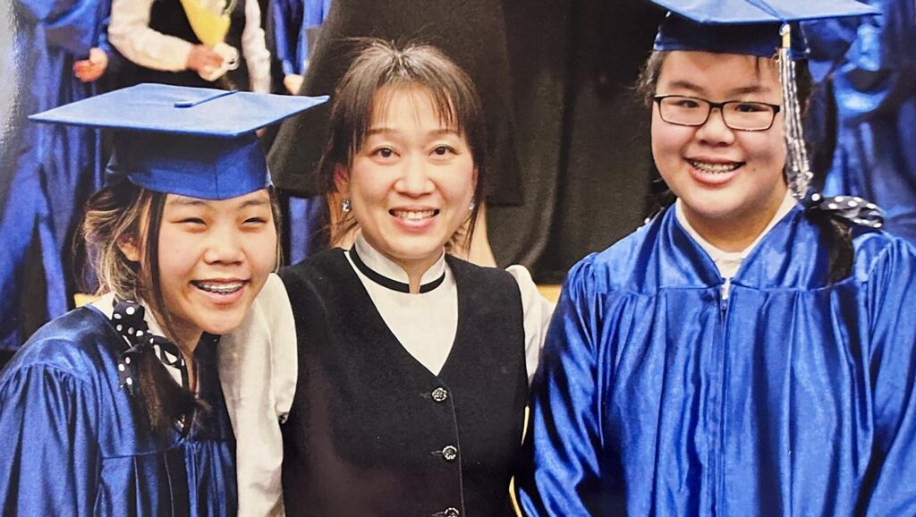 Chloe Chen (right) and a fellow graduate take a commemorative photo with IFang Miao