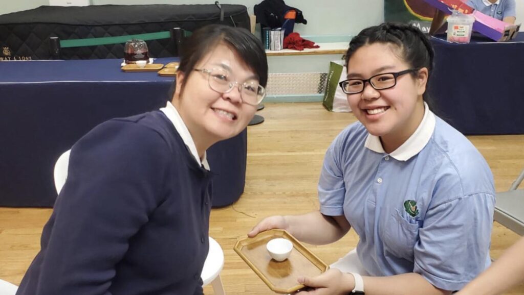 Chloe Chen serves tea to her mother