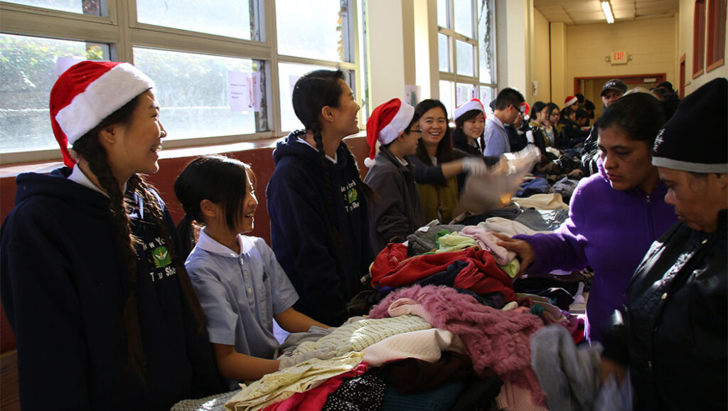 Students at Tzu Chi Academy, Long Island, and their family members assist with a winter clothing distribution