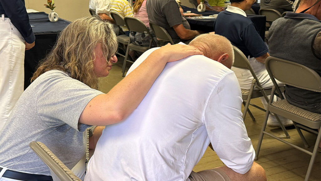 Bobbie Rae Jones comforts a distraught participant during the guided meditation session