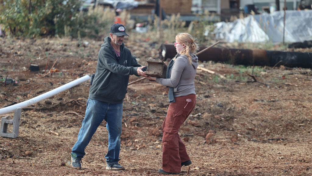 Havyn Morris helps her grandfather James Morris move bricks